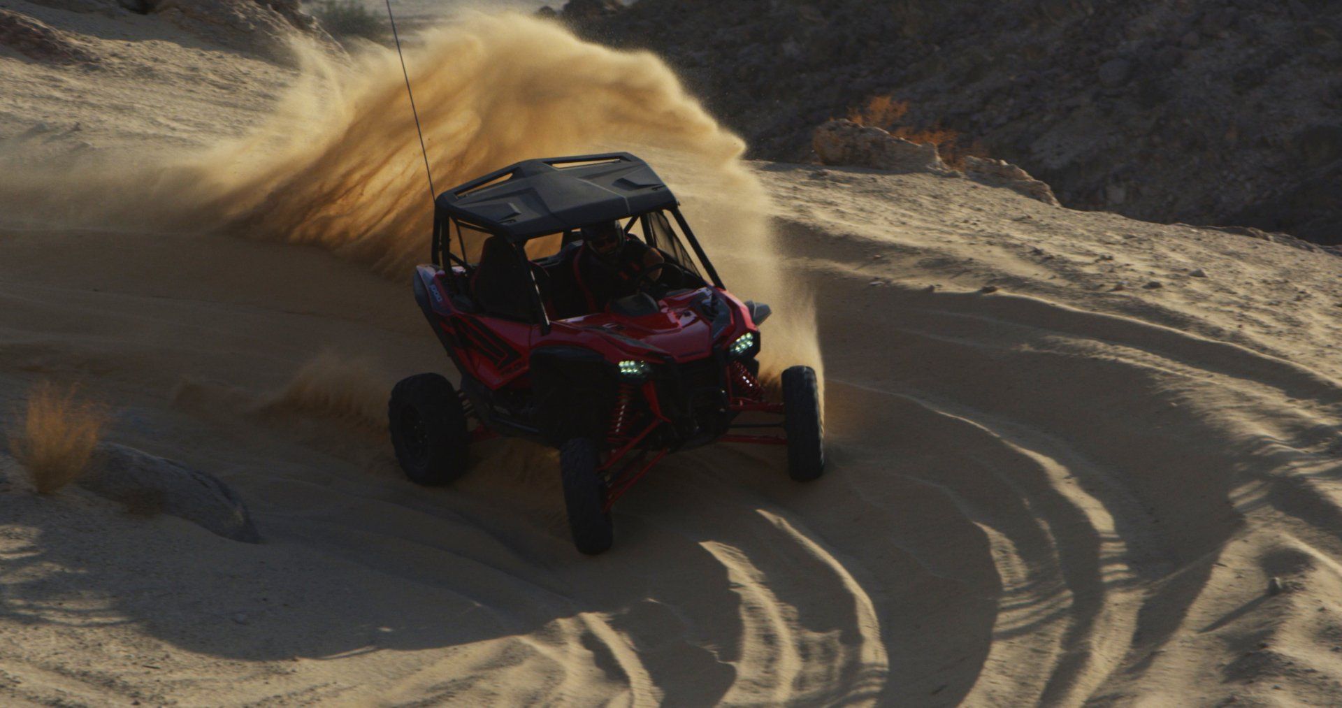 red UTV turning curve in borrego springs mountain