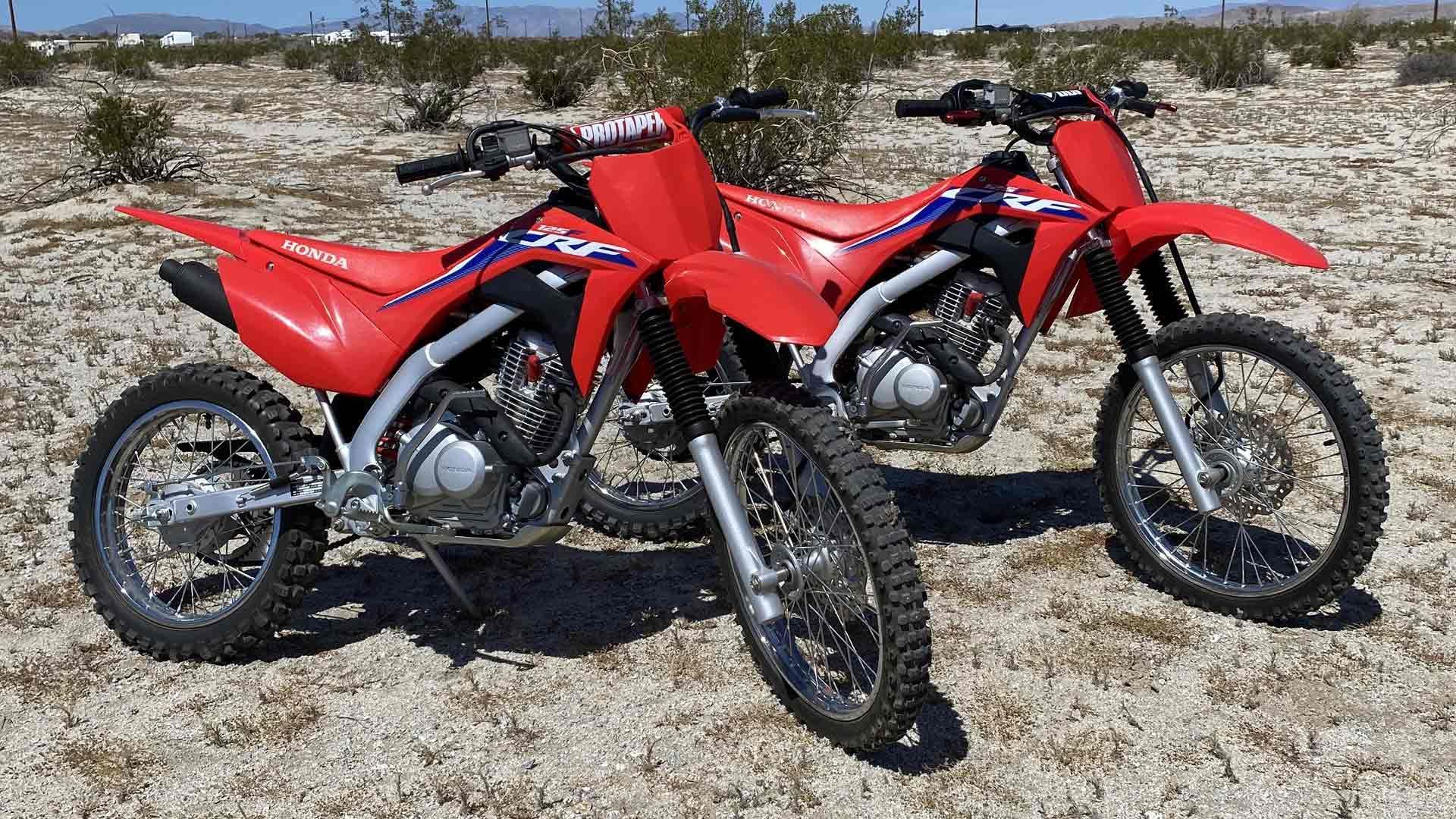 man on dirt bike riding through forest