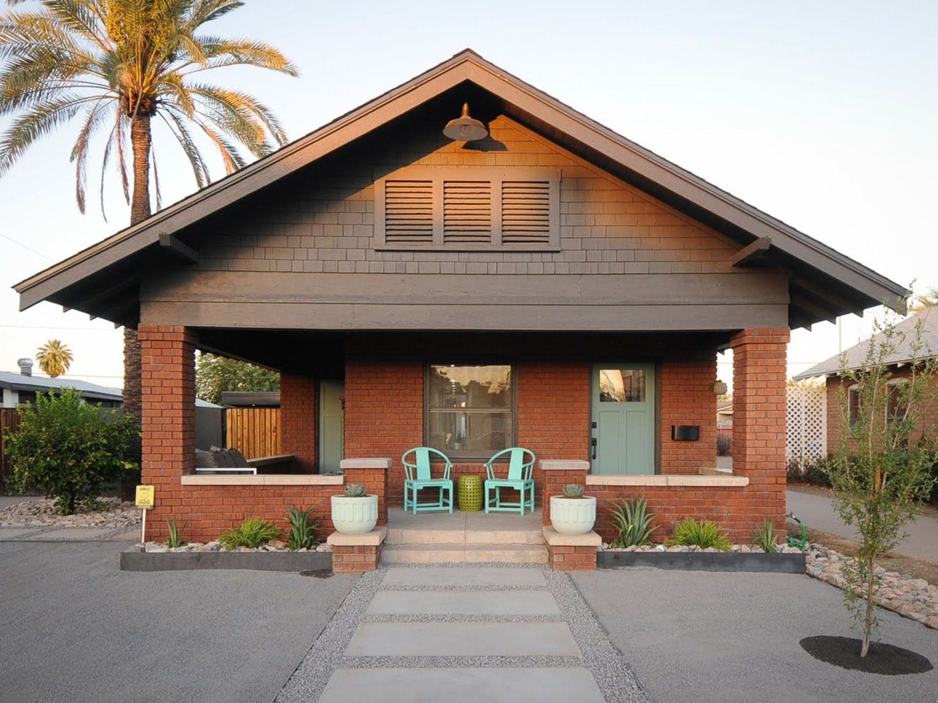 A brick house with a palm tree in the background