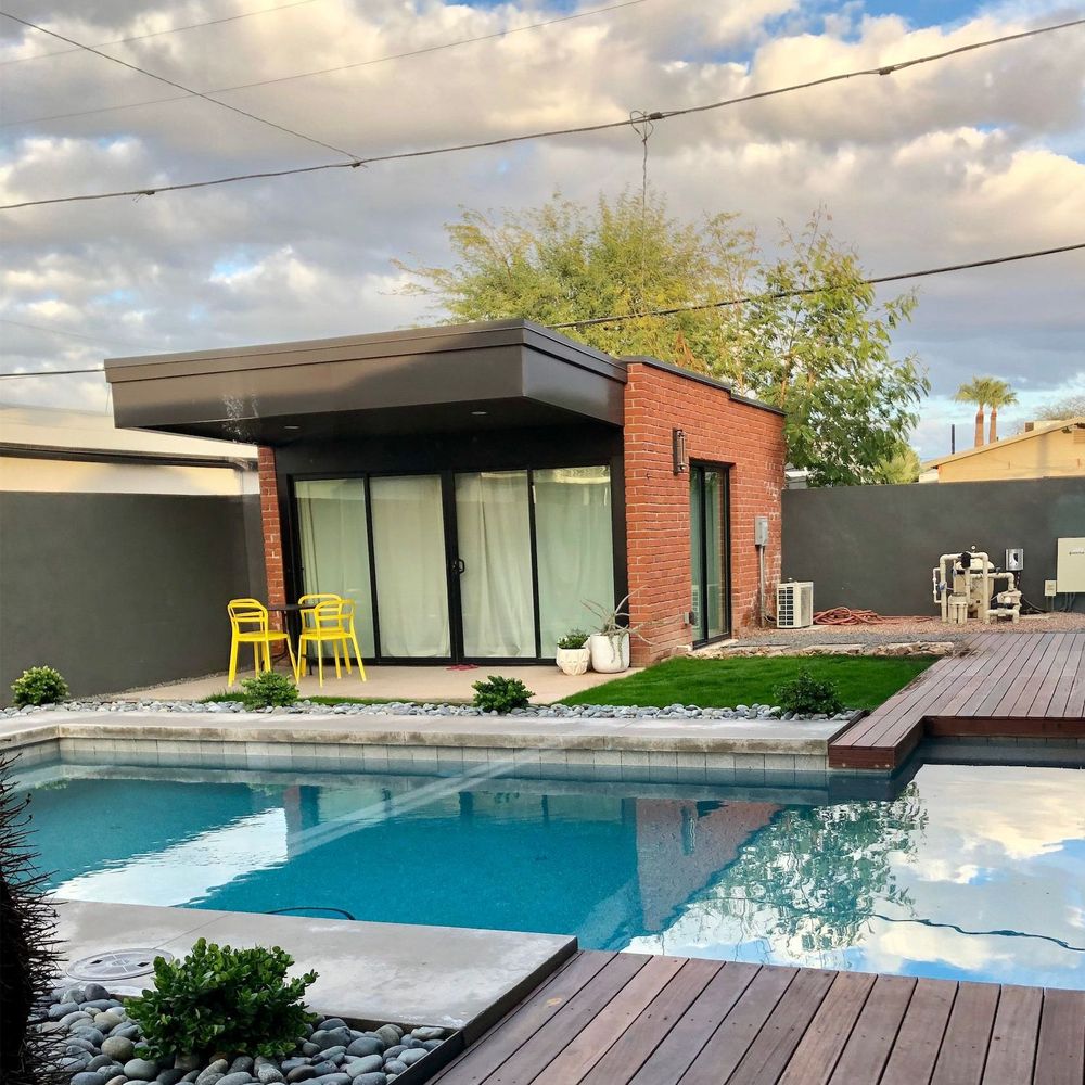 A modern house with a large swimming pool in the backyard.