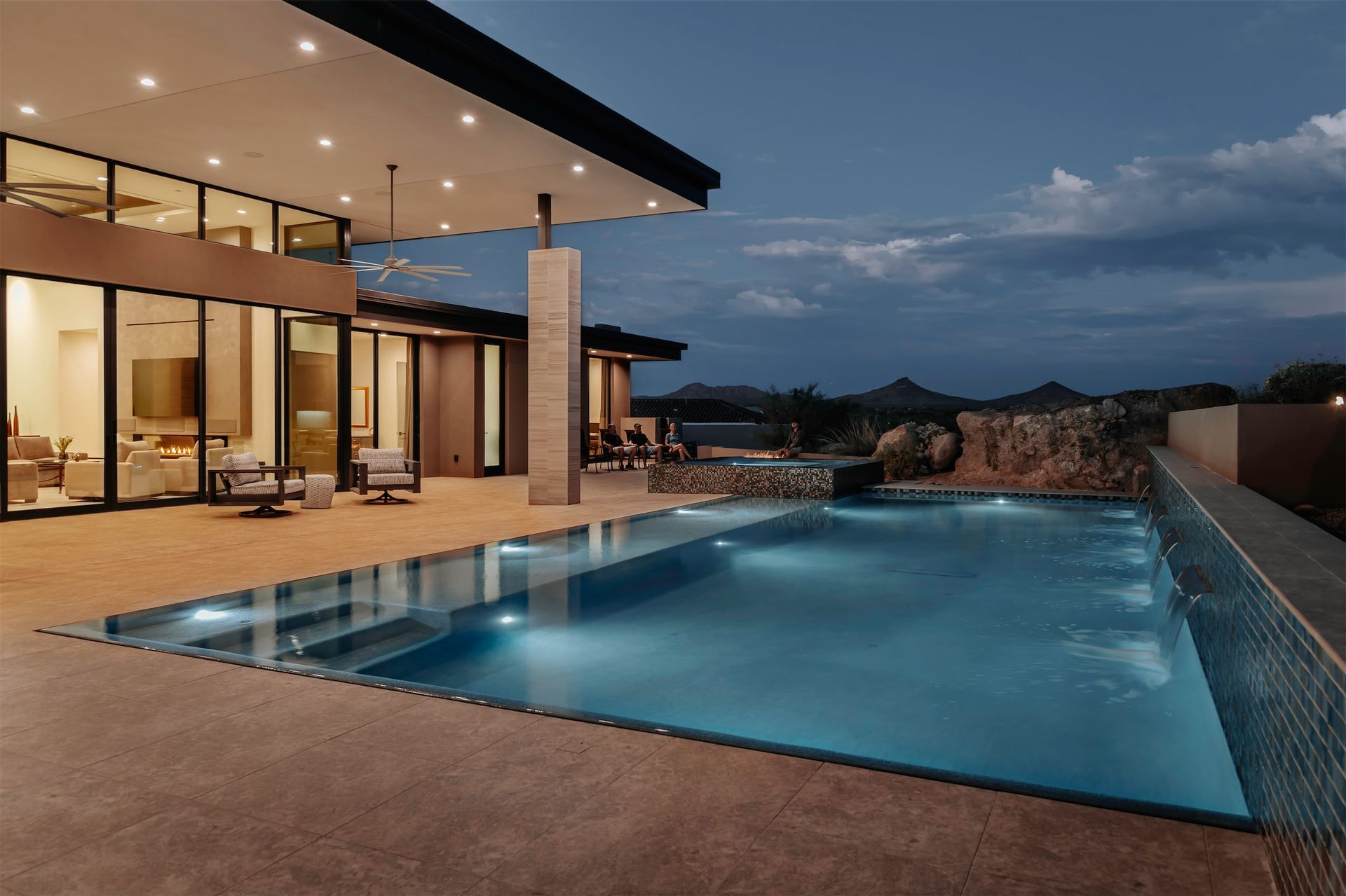 A large house with a swimming pool in front of it