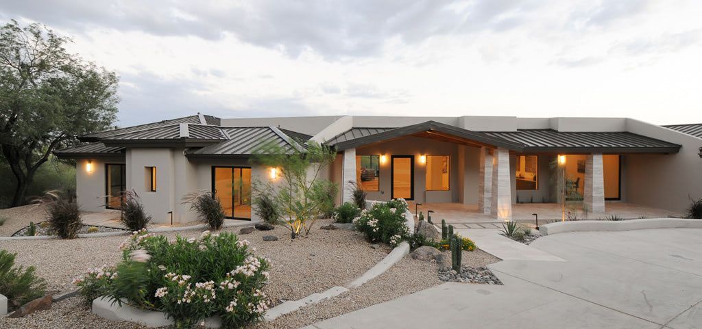 A large house with a lot of windows and a driveway