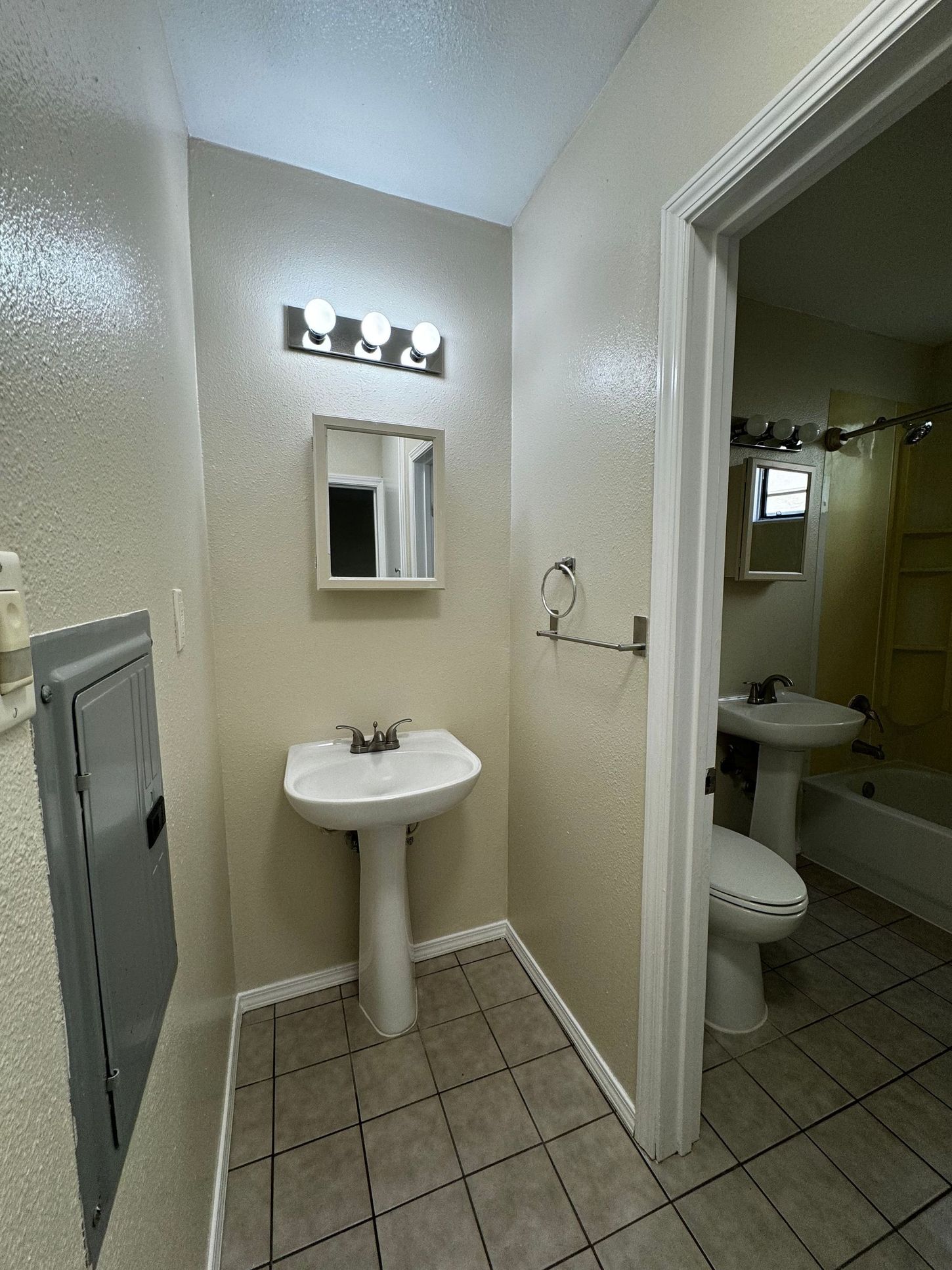 A bathroom with a sink , toilet , and mirror.