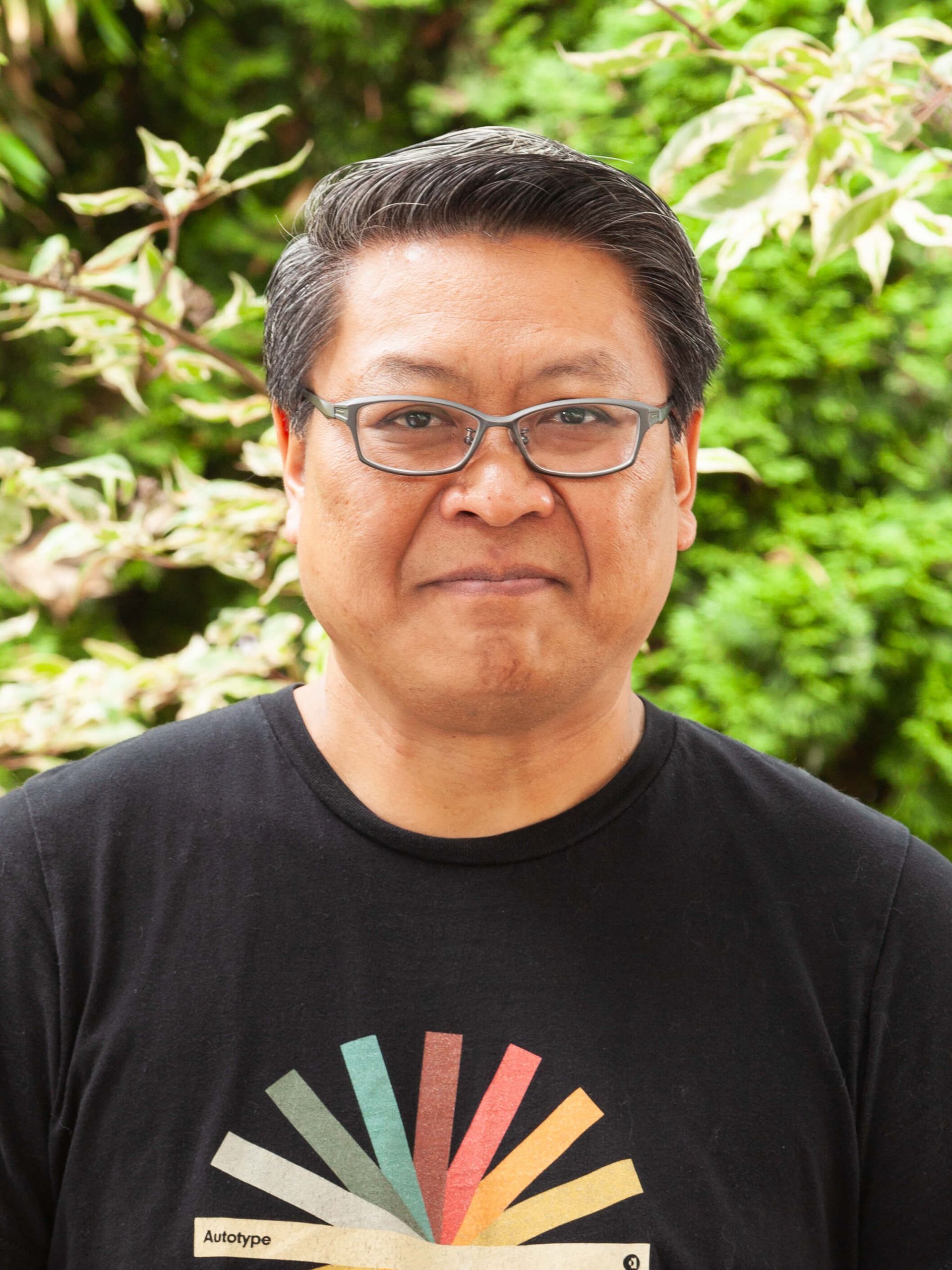 Man smiling and wearing glasses.