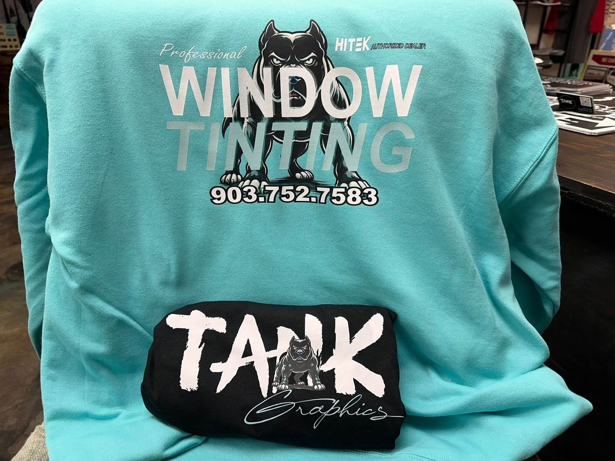 Turquoise sweatshirt with “WINDOW TINTING” text and black “TANK” graphic on the front.