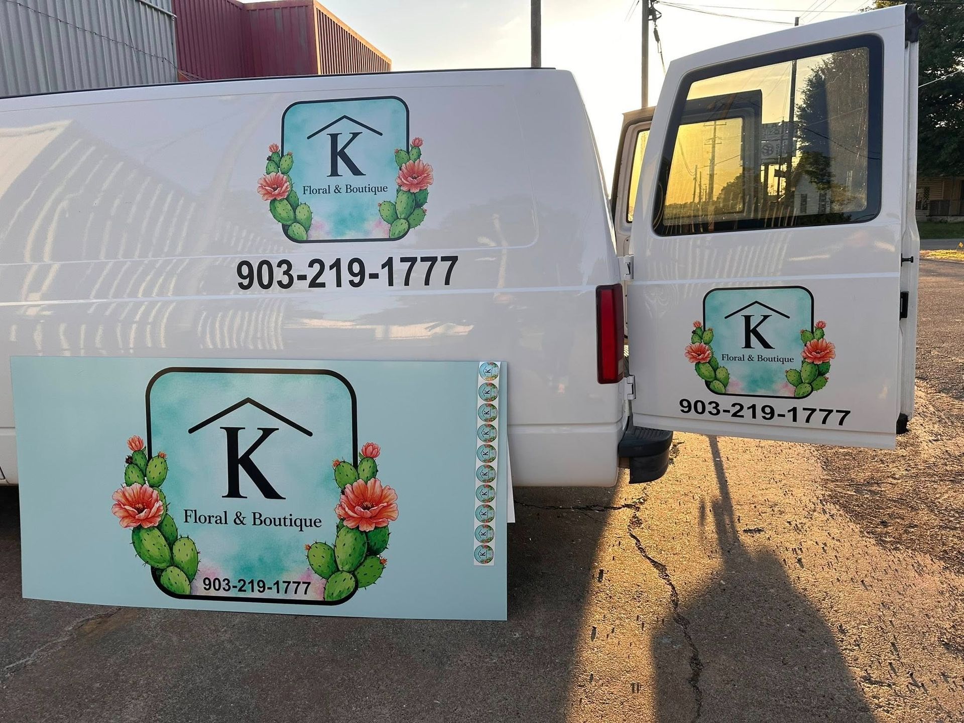 Florist delivery van with floral “K” logo and phone number 903-219-1777 on the side and door