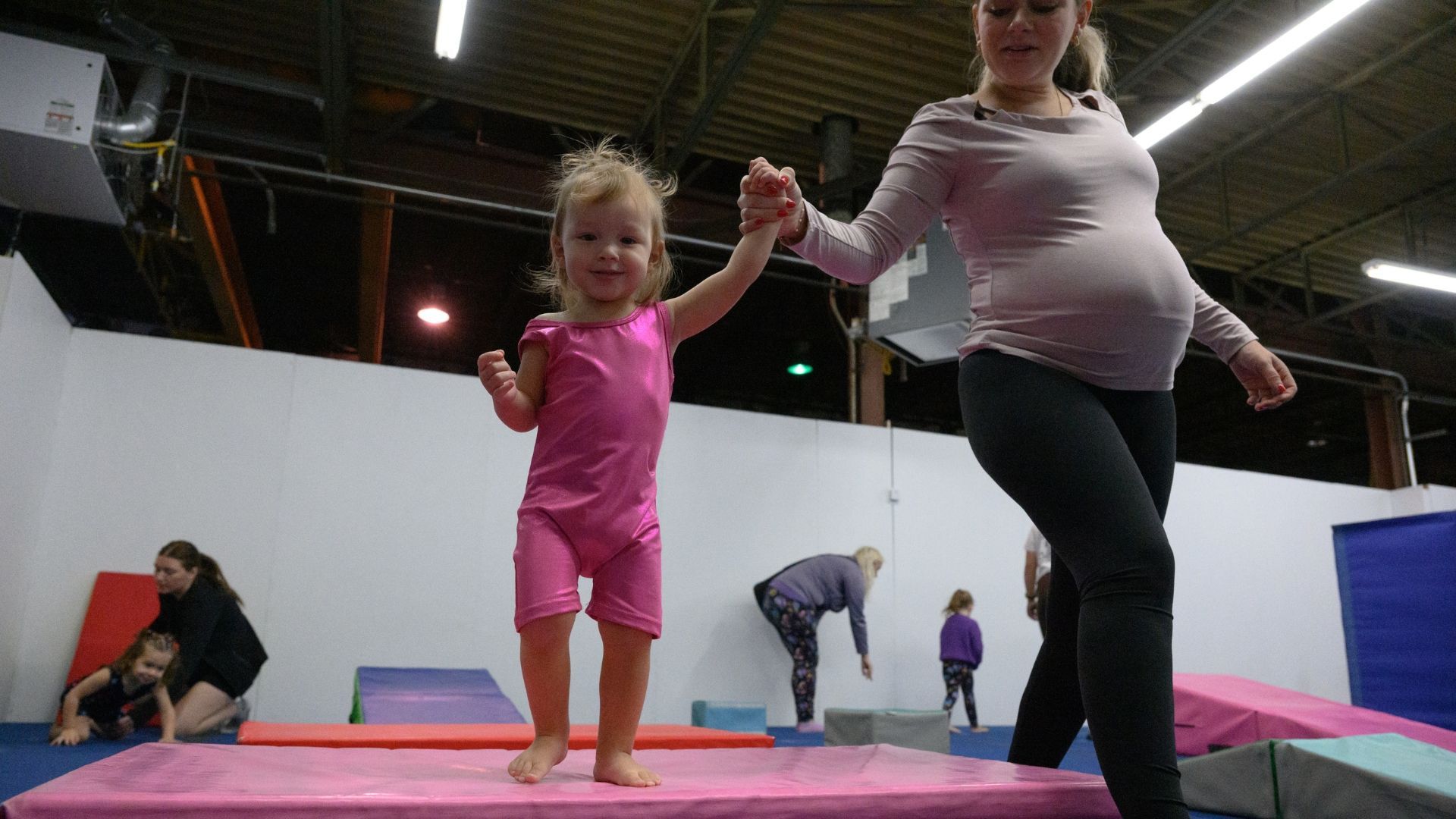 Toddler exploring the gym during Tumble Time
