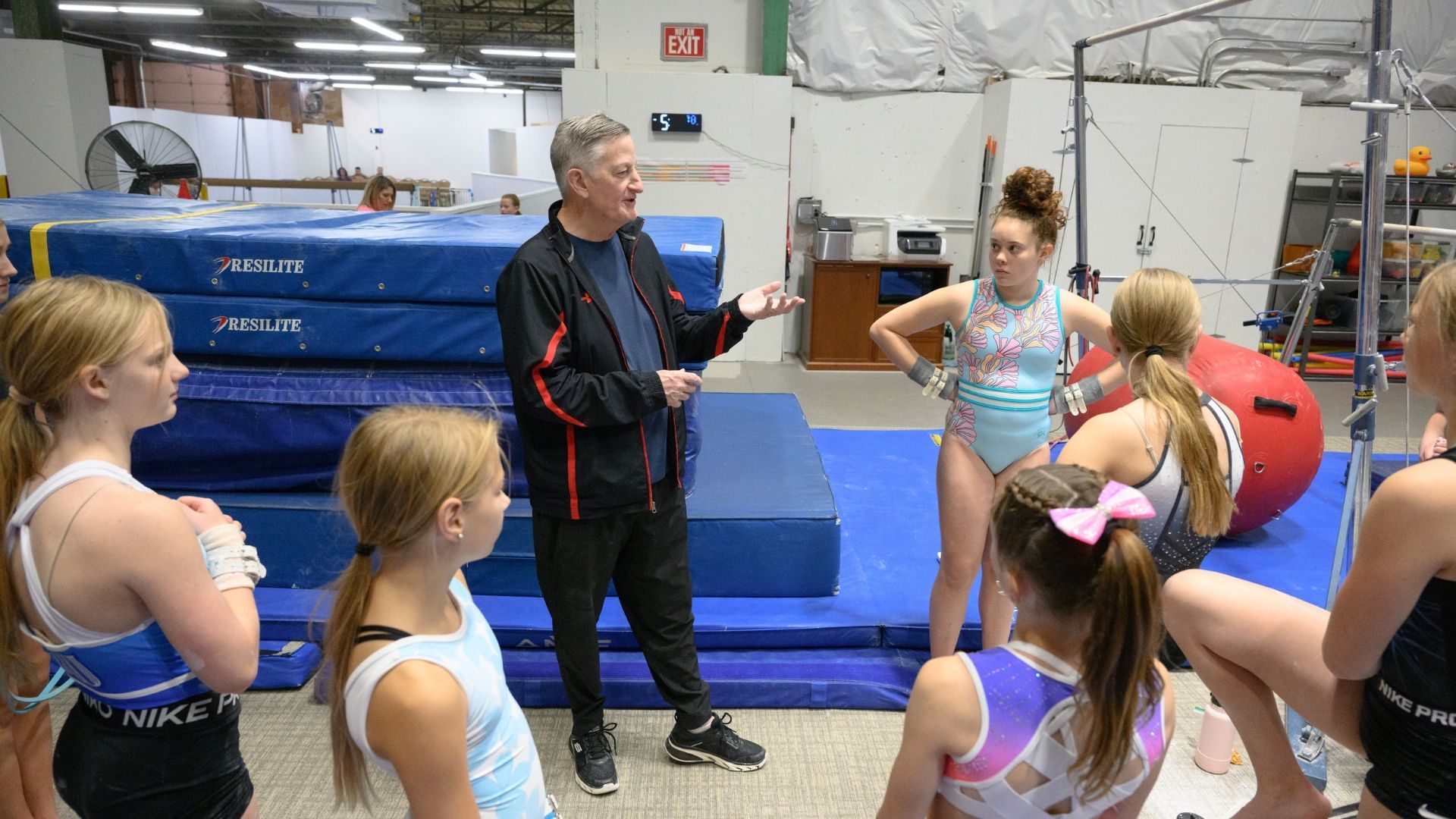 Coach working with developmental team gymnasts