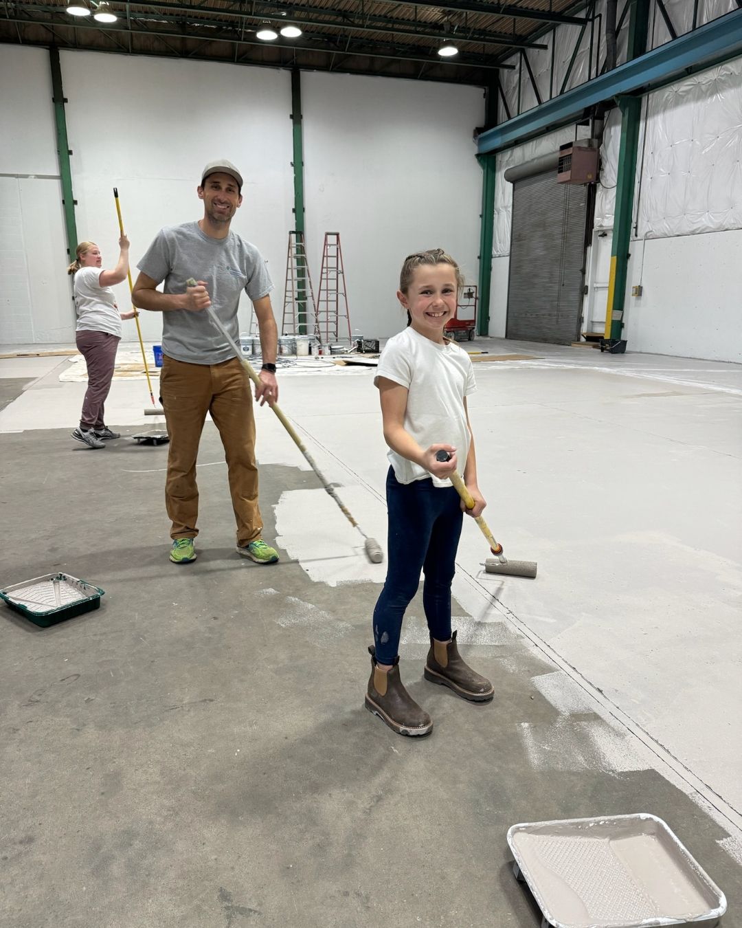 Volunteers cleaning the floor of the new gym