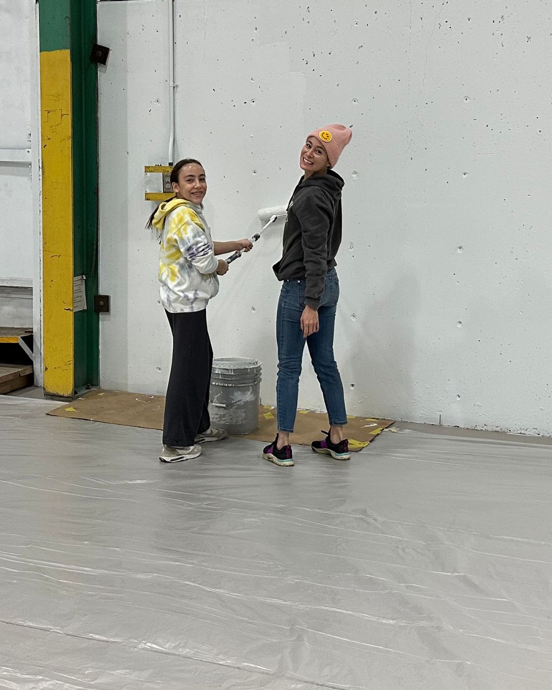 Volunteers painting a wall in the new gym