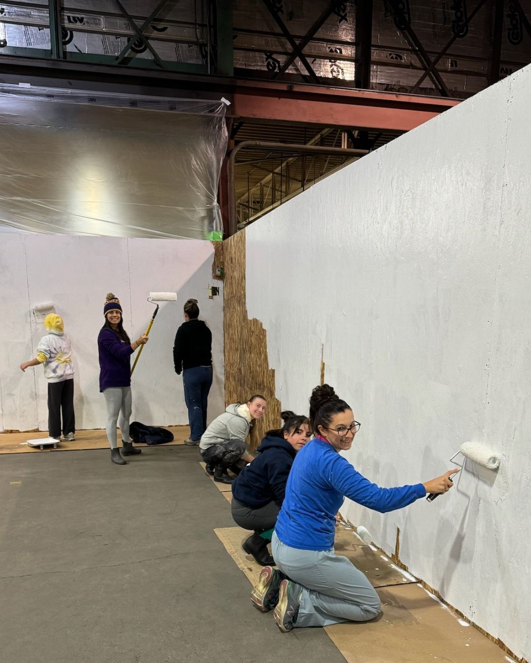 Volunteers painting the walls of the new gym