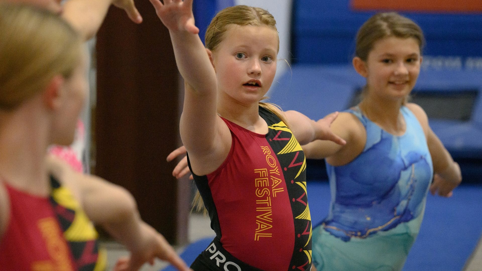 Xcel team gymnast saluting at a competition