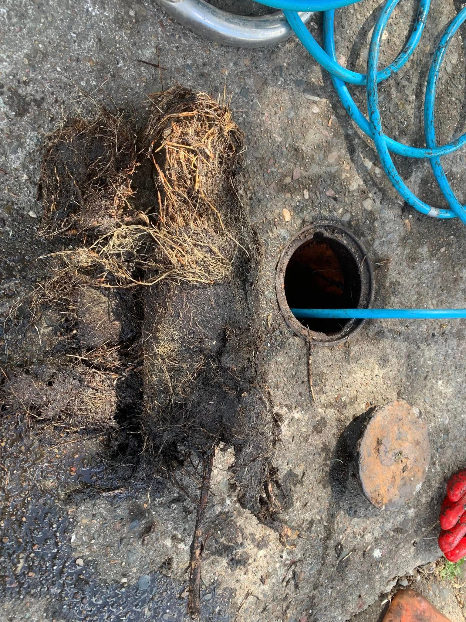 A plumbing camera set up to find blockage issues going down a pipe and some tools around on a tiled floor — Delaney Plumbing Services In Taree, NSW