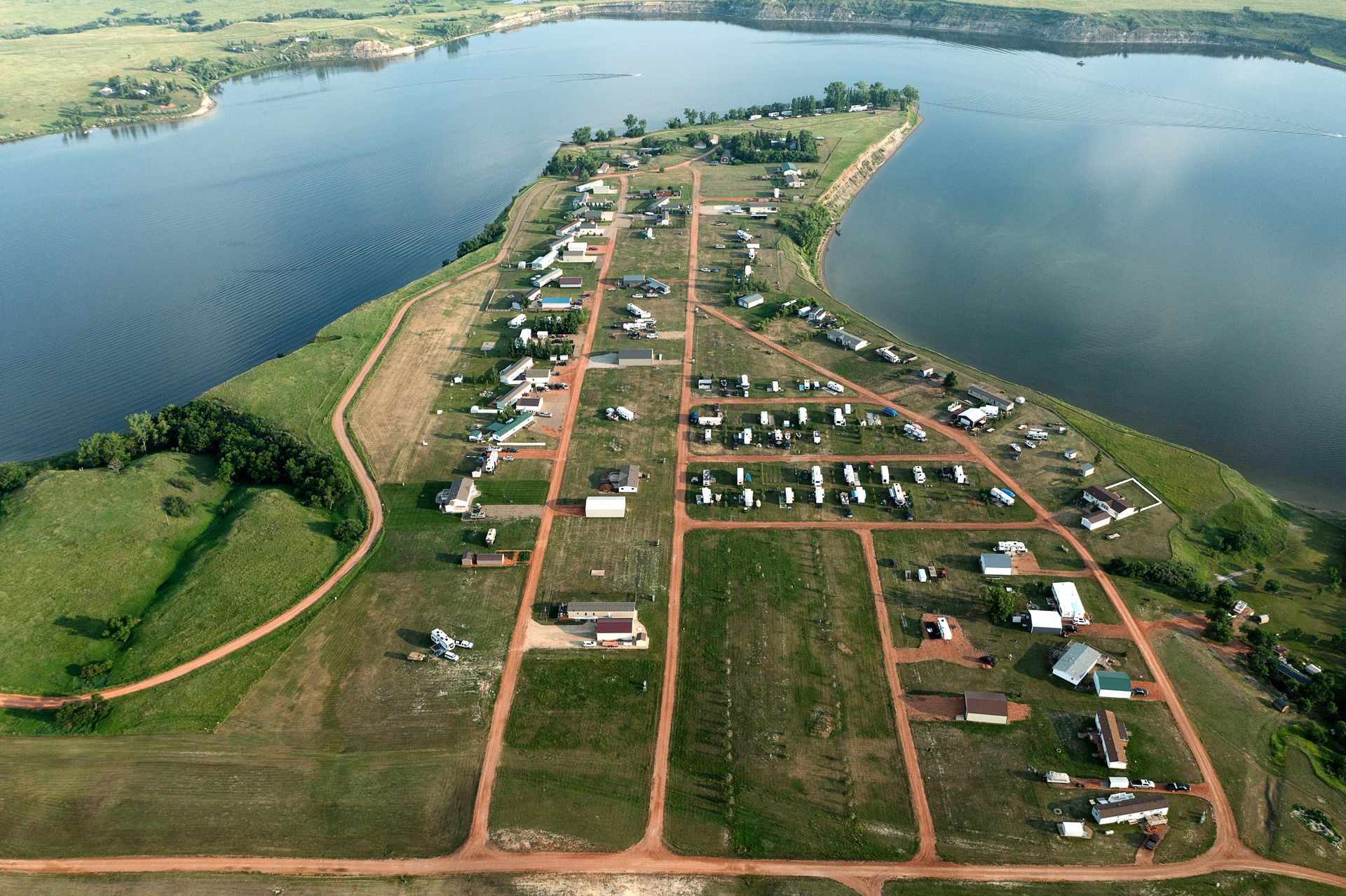An aerial view of a small town on the shore of a lake