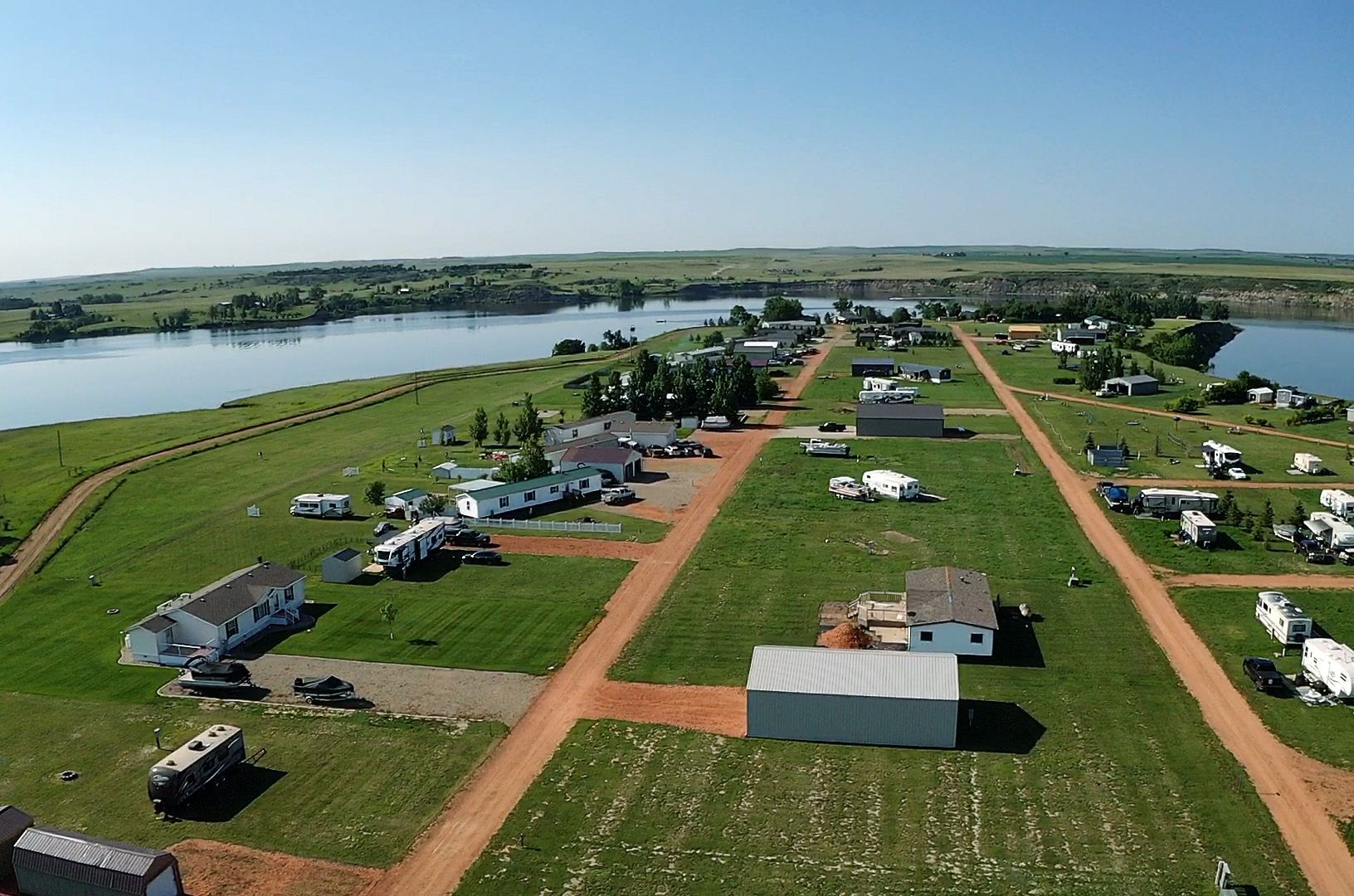 An aerial view of a small town with a lake in the background