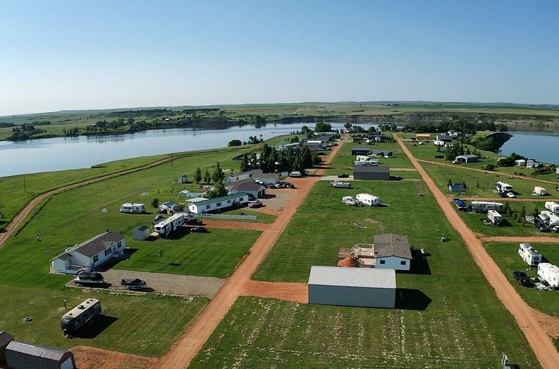 An aerial view of a small town with a lake in the background