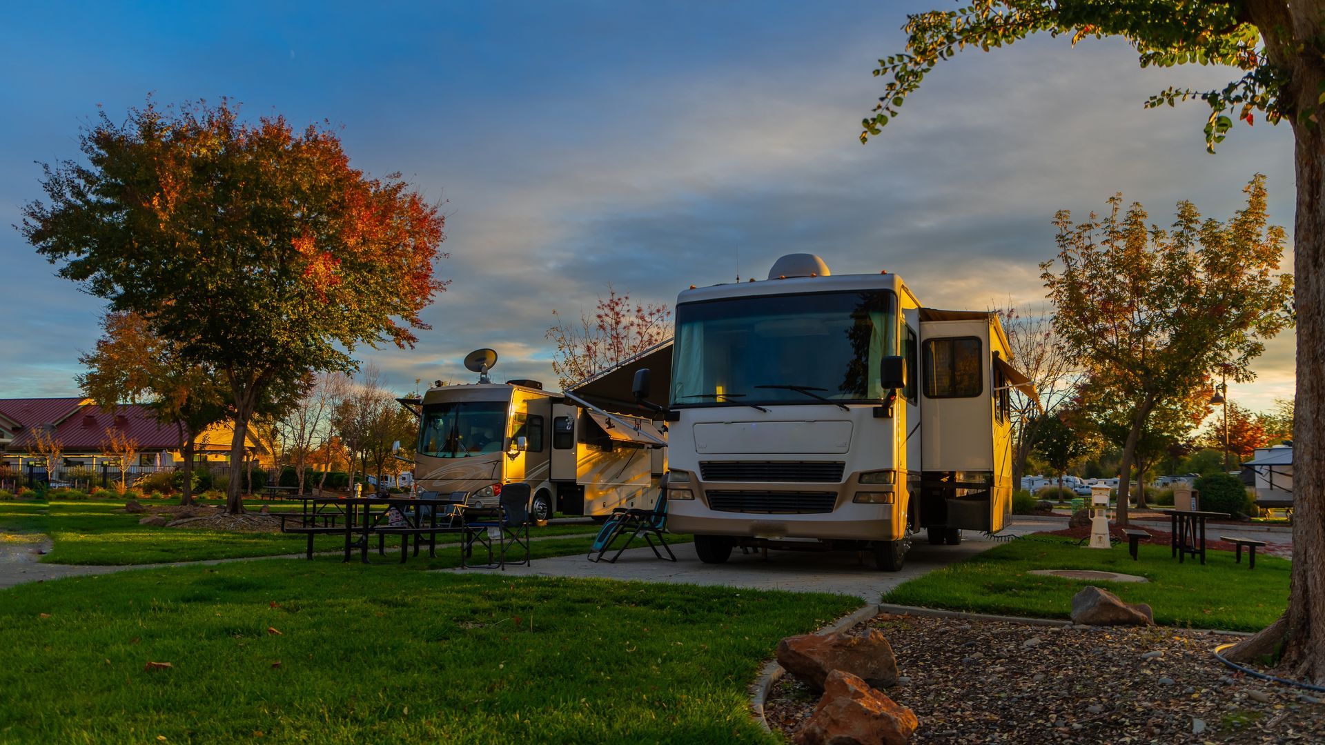 A couple of rvs parked next to each other in a park.