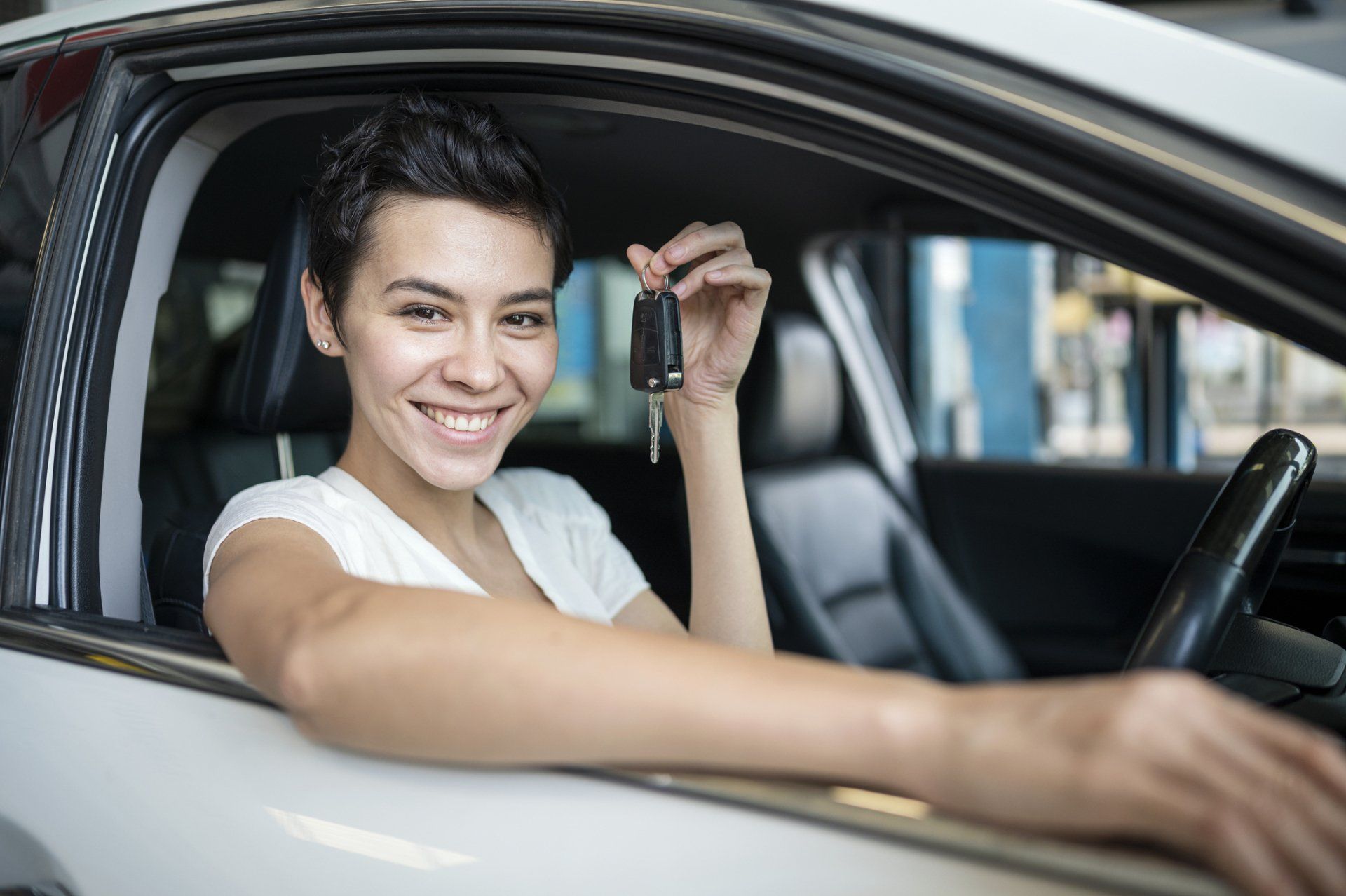 Women customer holding a car key — Salt Lake City, UT — Advance Insurance SLC