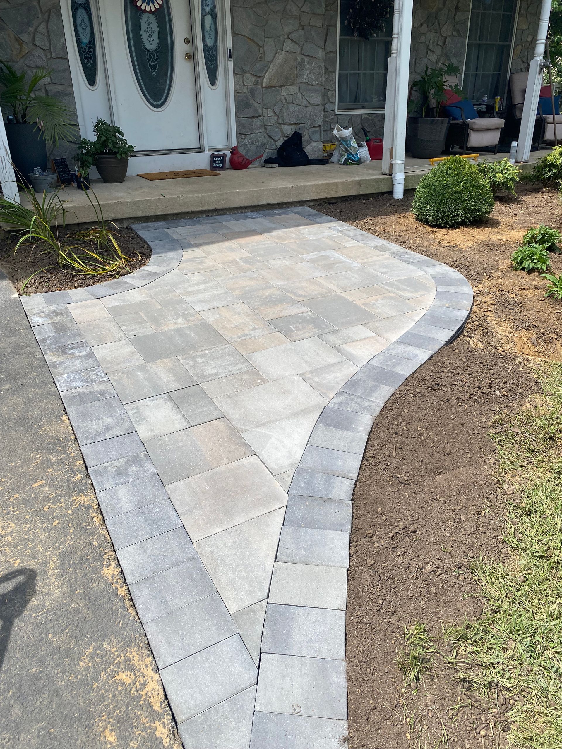 A walkway is being built in front of a house.