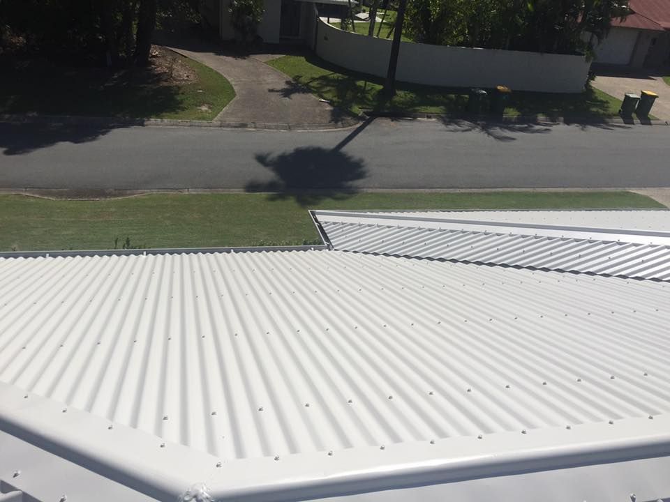 A White Roof With a Shadow of a Palm Tree on It — Dezigner Finishes Professional Painting & Decorating in Palmview, QLD