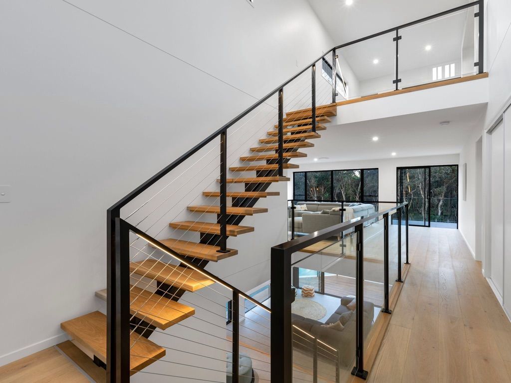 A Ladder is Leaning Against a Wall in a Room — Dezigner Finishes Professional Painting & Decorating in Palmview, QLD
