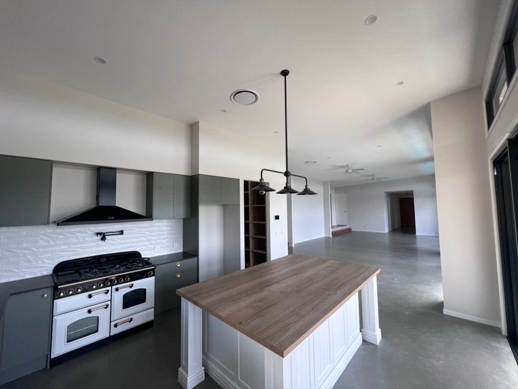 An Empty Room With a Ceiling Fan — Dezigner Finishes Professional Painting & Decorating in Palmview, QLD