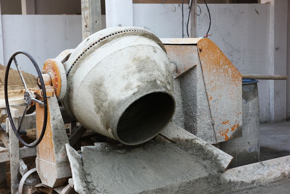 A Concrete Mixer Is Pouring Concrete Into A Bucket — T&G Sand and Gravel In Sippy Downs, QLD