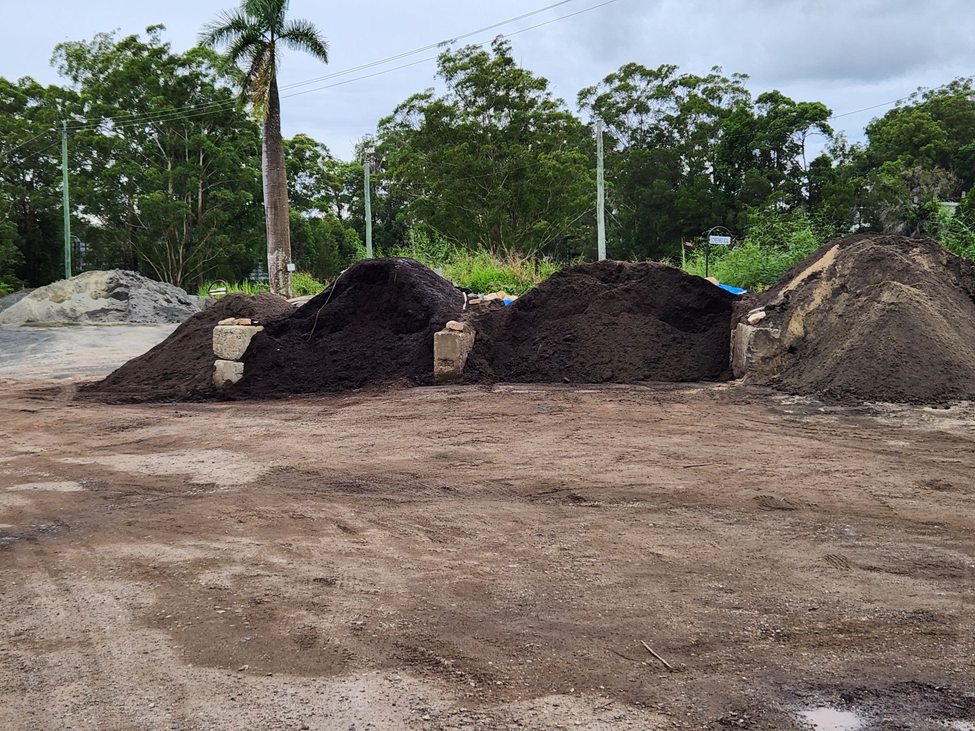 Piles of Dark Soil and Sand Sit on a Dirt Lot — T&G Sand and Gravel In Sippy Downs, QLD