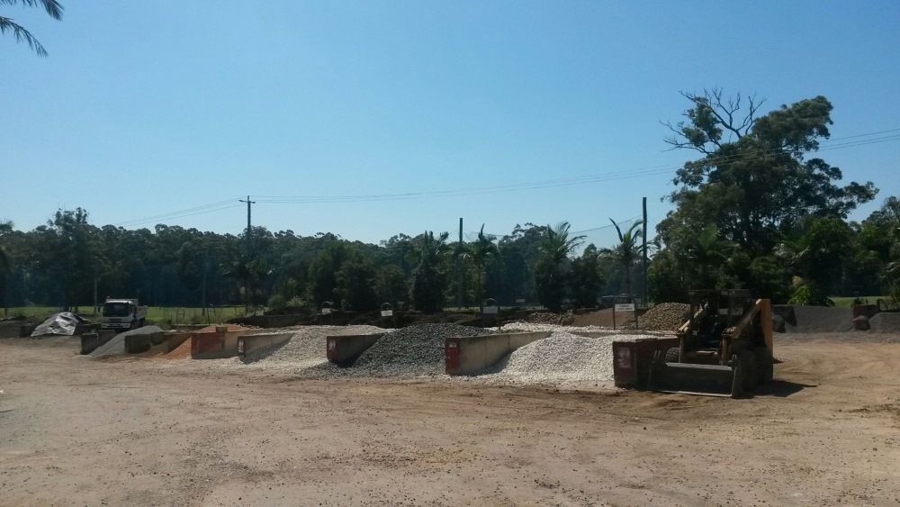A Large Pile Of Dirt In A Field With Trees In The Background — T&G Sand and Gravel In Sippy Downs, QLD