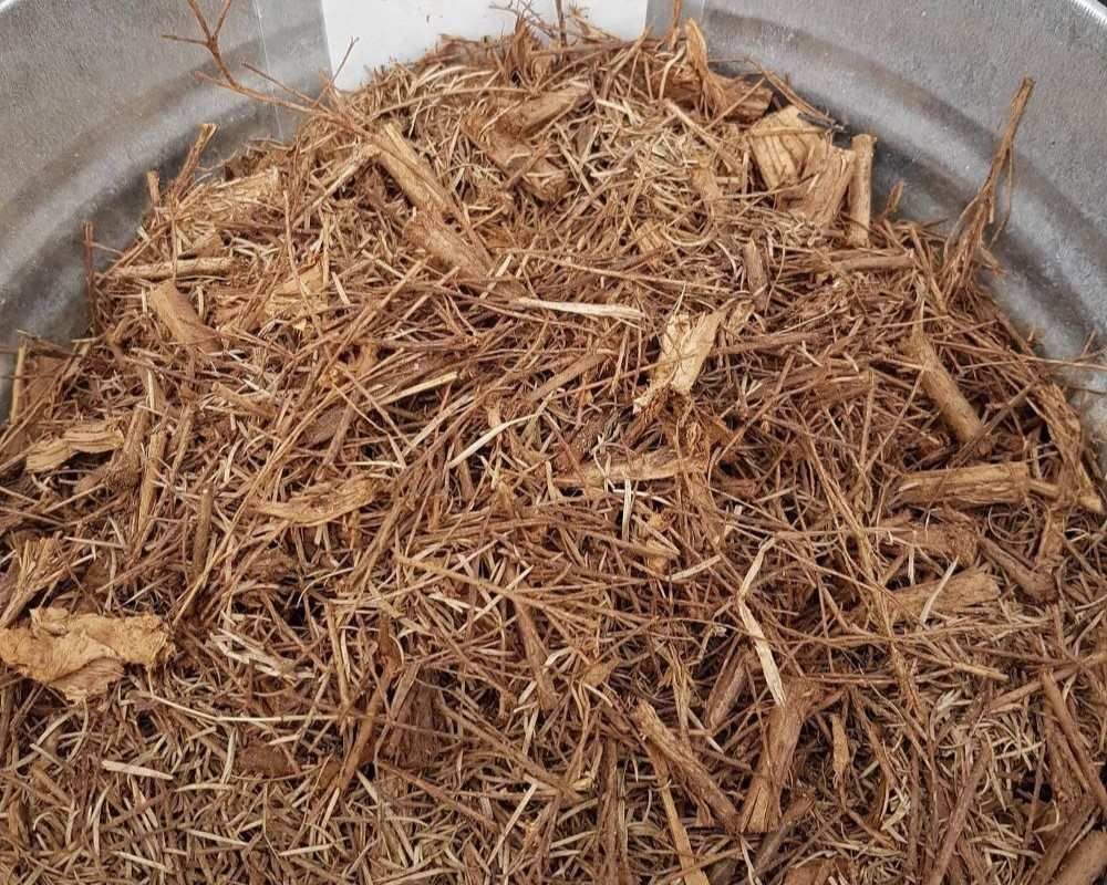 A Pile Of Wood Chips Is Sitting In A Metal Bowl — T&G Sand and Gravel In Sippy Downs, QLD