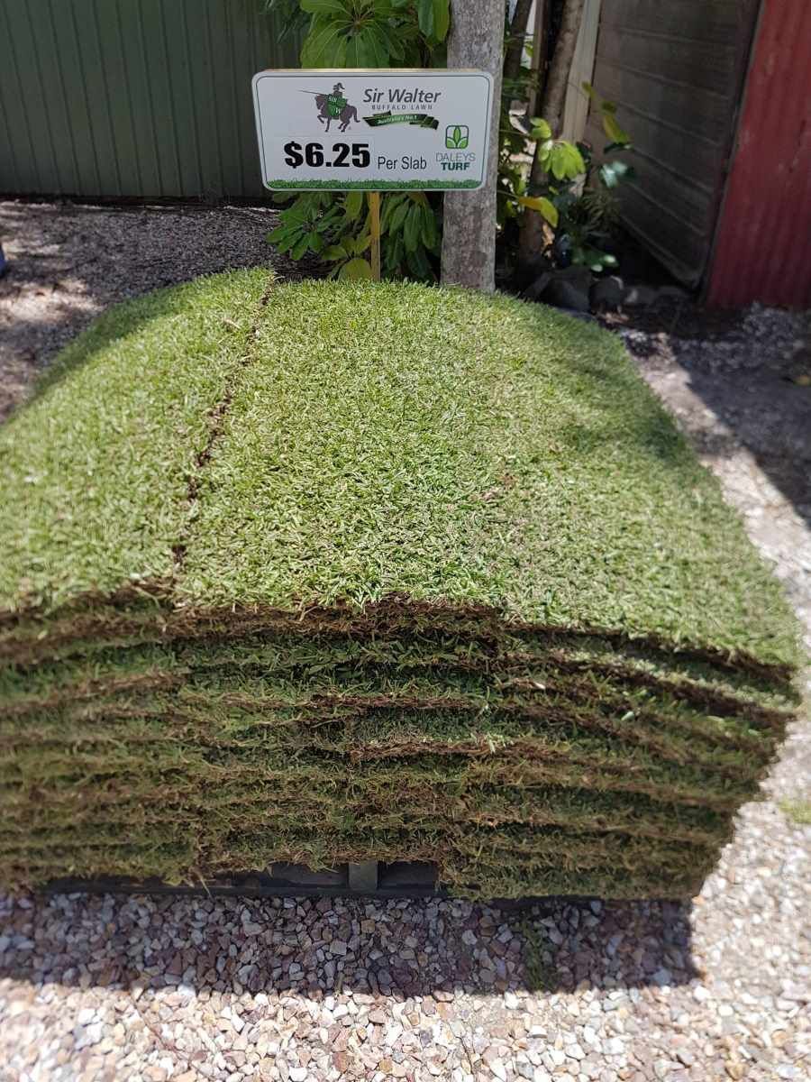 A Pile Of Grass Is Sitting On The Ground Next To A Sign — T&G Sand and Gravel In Sippy Downs, QLD