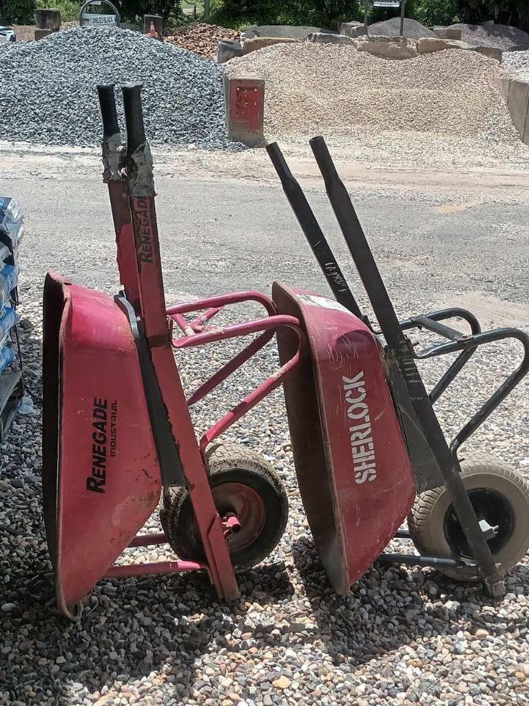 Two Wheelbarrows Are Sitting Next to Each Other on a Gravel Road — T&G Sand and Gravel In Sippy Downs, QLD