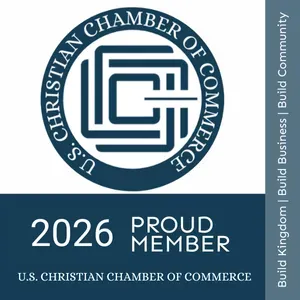 2026 U.S. Christian Chamber of Commerce proud member logo with blue-and-white emblem and vertical mission text