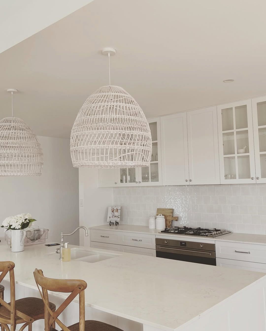 White Kitchen With Woven Pendant Lights and Cabinets — Brett Cox Electrical and Solar in Gumly Gumly, NSW