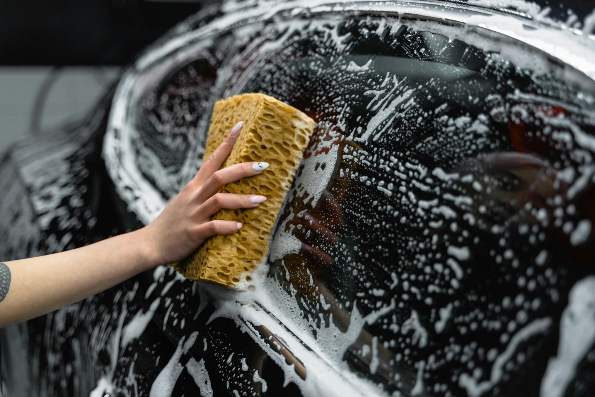 a person detailing a vehicle