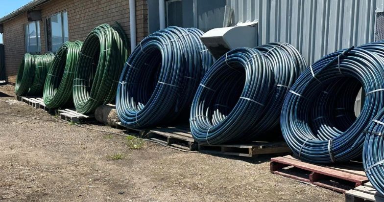 A Bunch Of Rolls Of Wire Are Sitting On Pallets Outside Of A Building — Dillon Rural In Nabiac, NSW