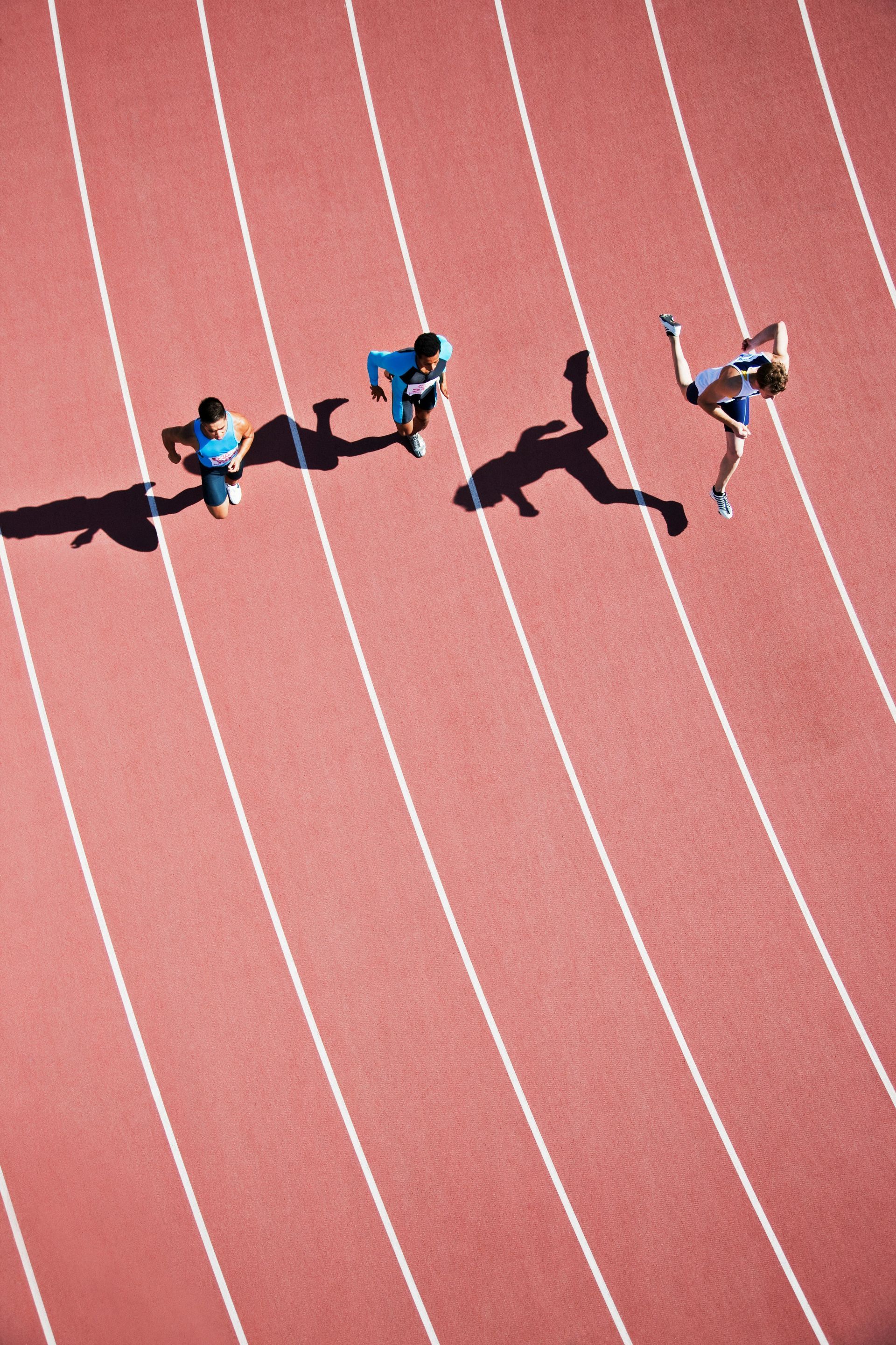 A group of people are running on a track