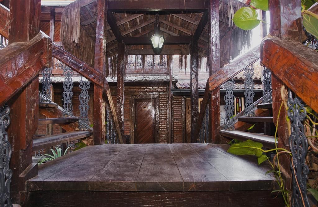 A wooden bridge with stairs leading up to a building.