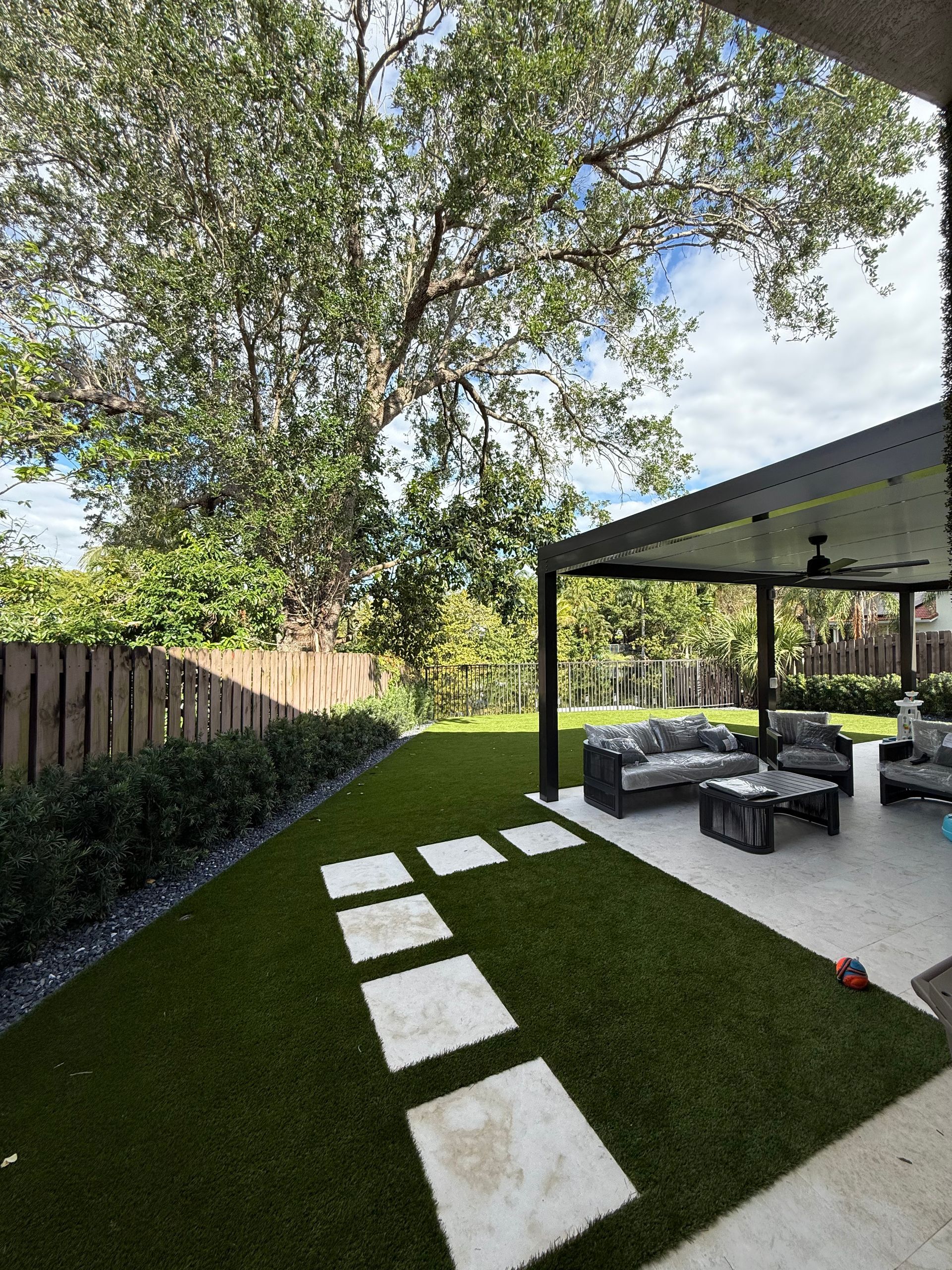 Stone pathway winding through a tropical garden with integrated landscape lighting.