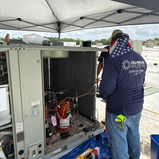 Technician diagnosing an air conditioning system.