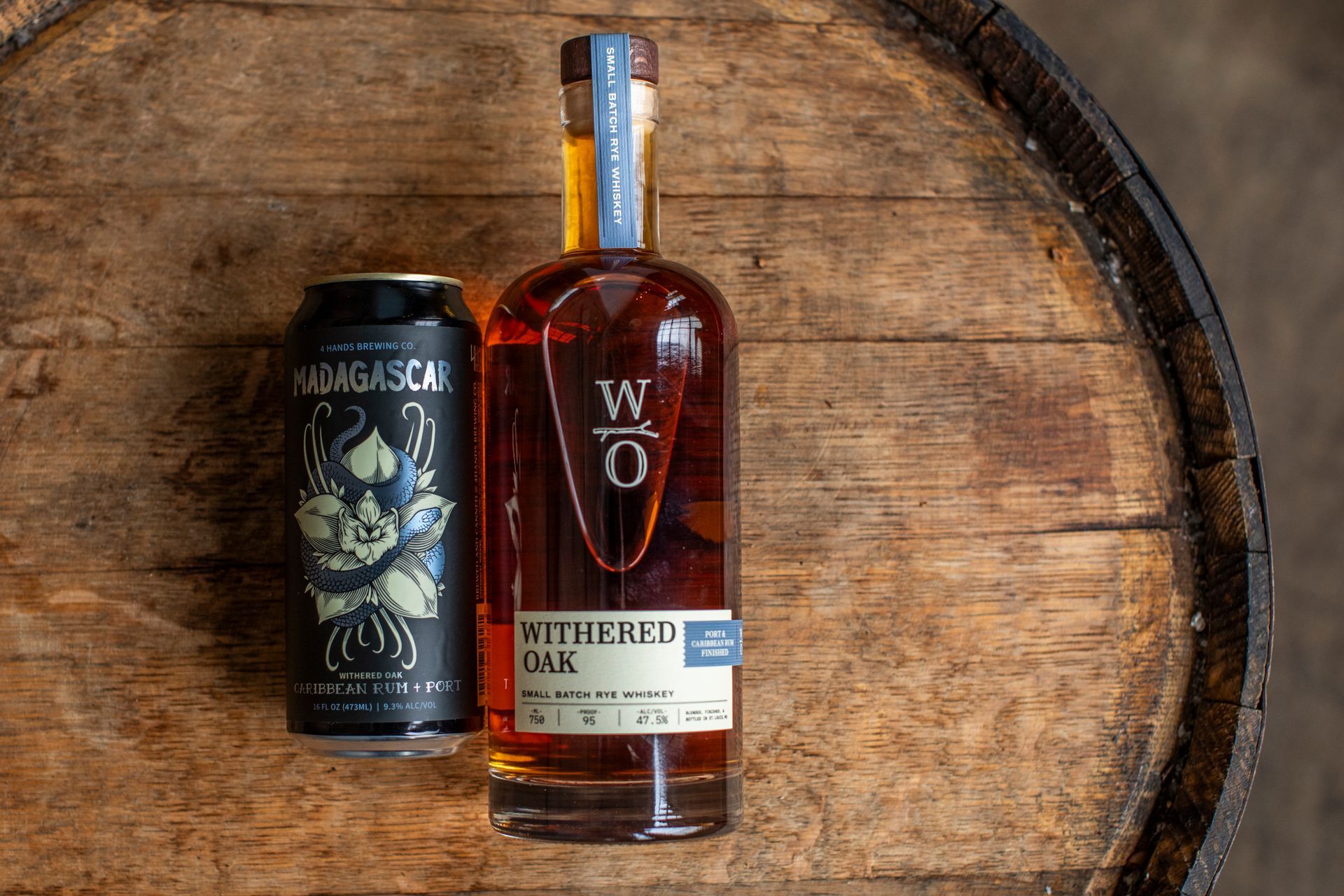 4 Hands Brewing Company's Madagascar Withered Oak can and a bottle of Withered Oak whiskey