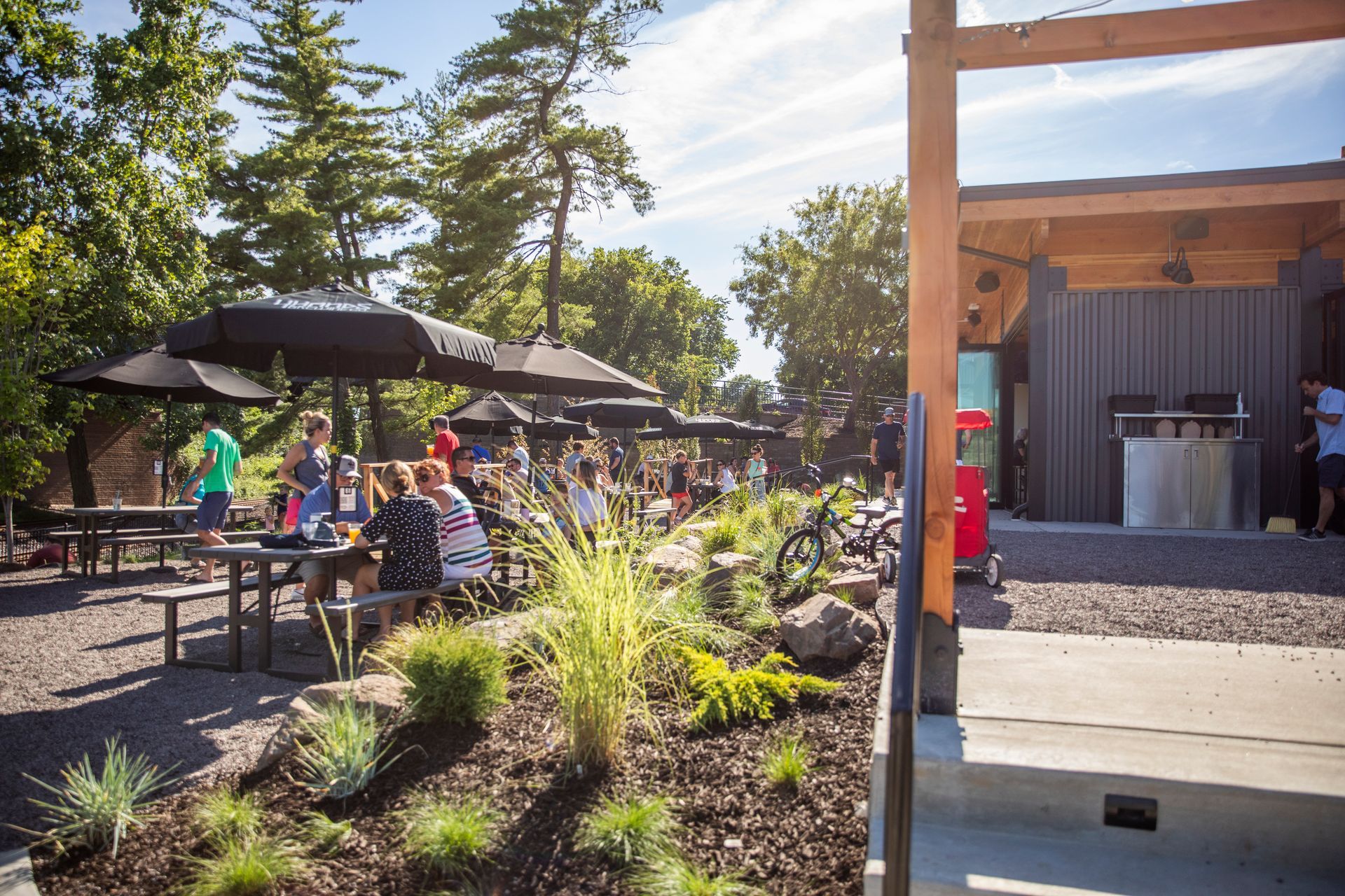 A group of people are sitting at a table in the backyard area at 4 Hands + Peacemaker Kirkwood