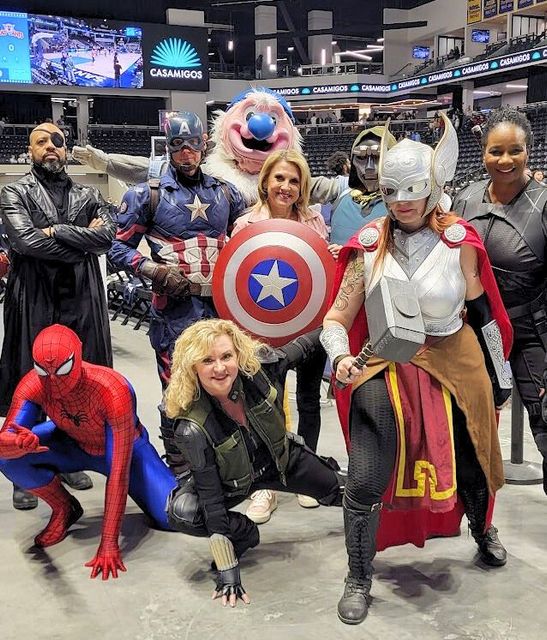 Rebecca Jones surrounded by Marvel superheroes