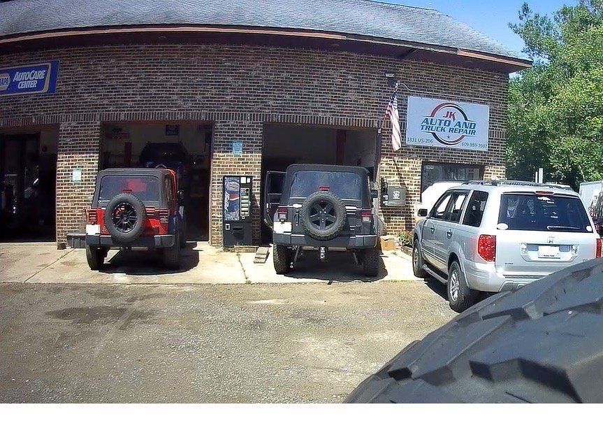 Auto Repair Shop Exterior With Vehicles Parked | JK Auto And Truck Repair