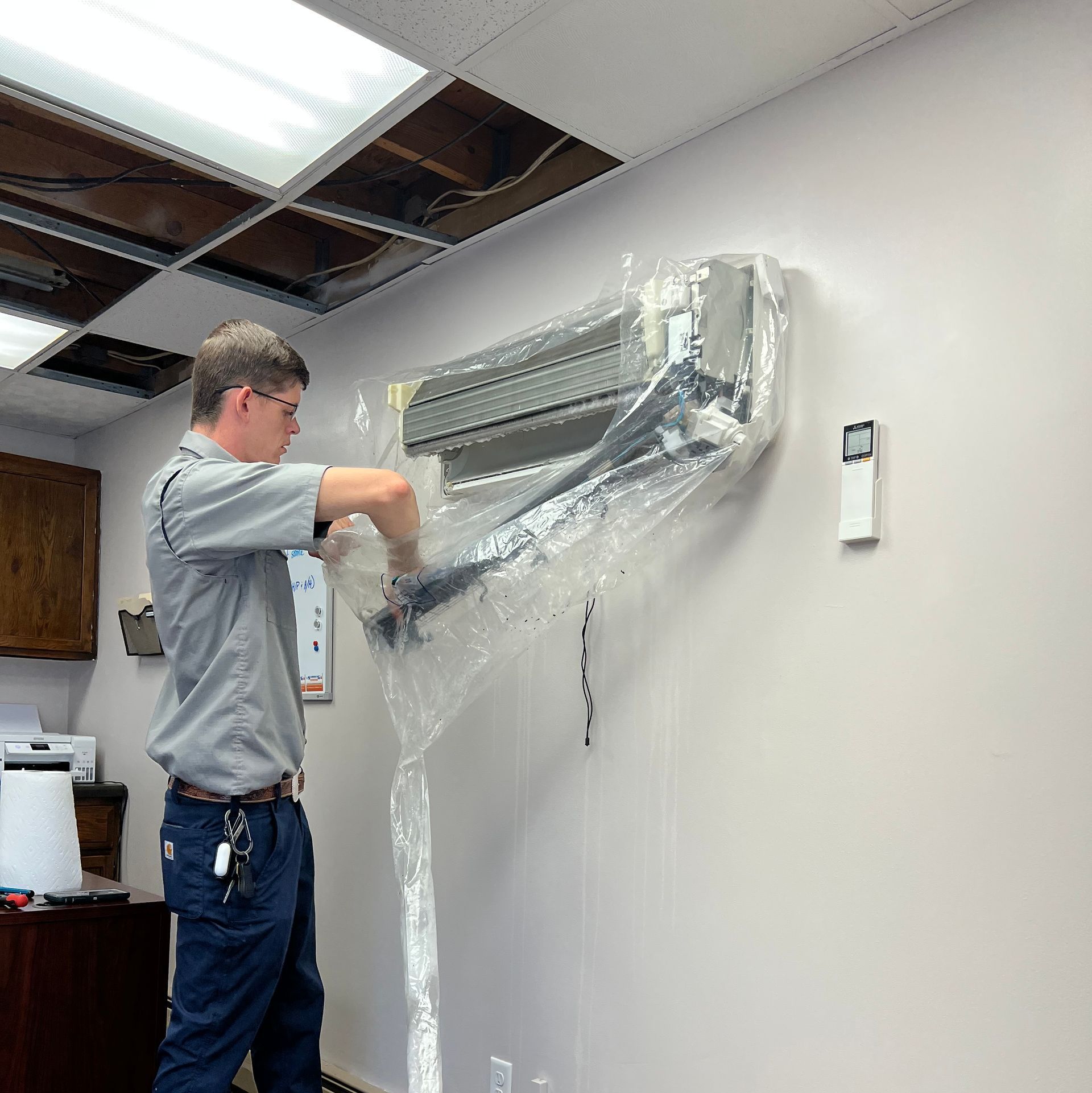 man working on ductless mini split