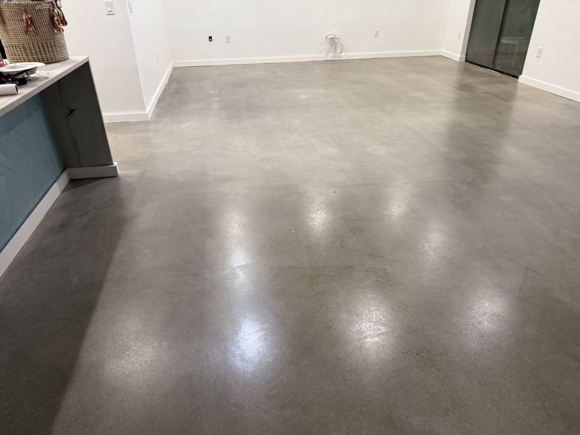 Dirty beige carpet with dark stains and visible traffic patterns in a room.