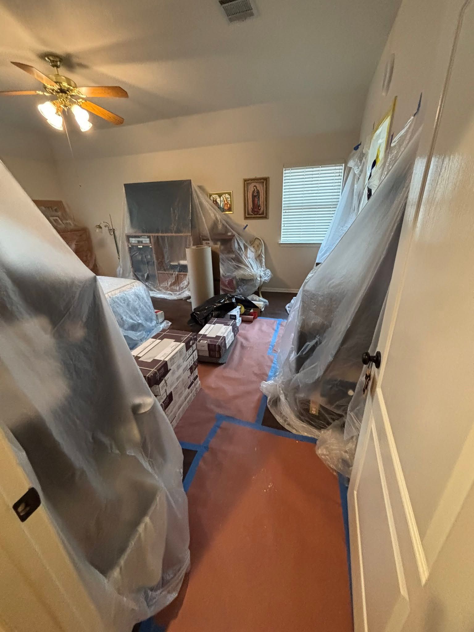 Carpet being cleaned with a vacuum cleaner, near a doorway. Light tan carpet.