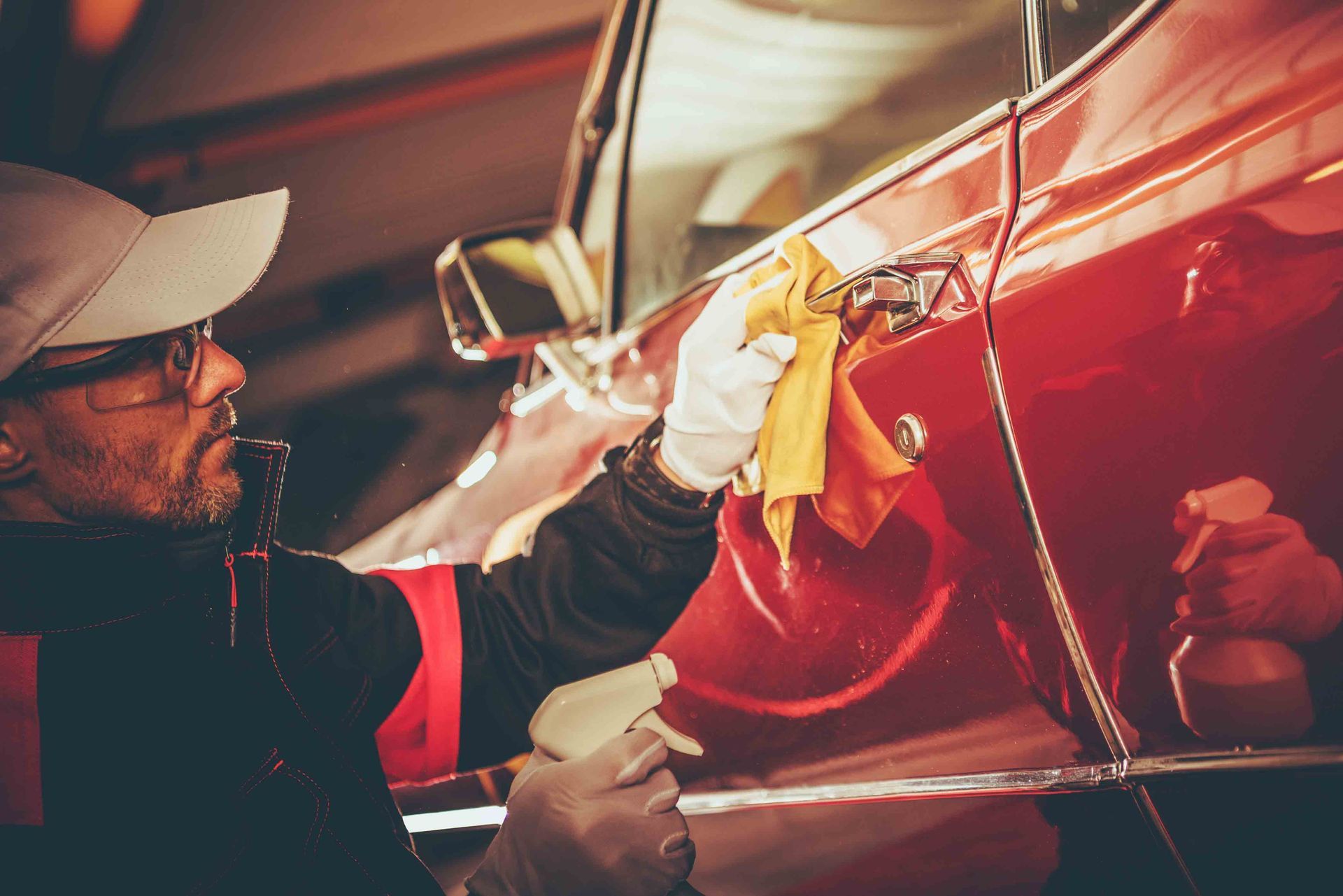 A man is restoring a classic car at Vintage Underground in Atherton, CA, showcasing expert skills to