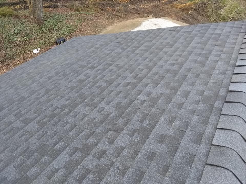 Dark gray shingled roof with a vent pipe, viewed from above.