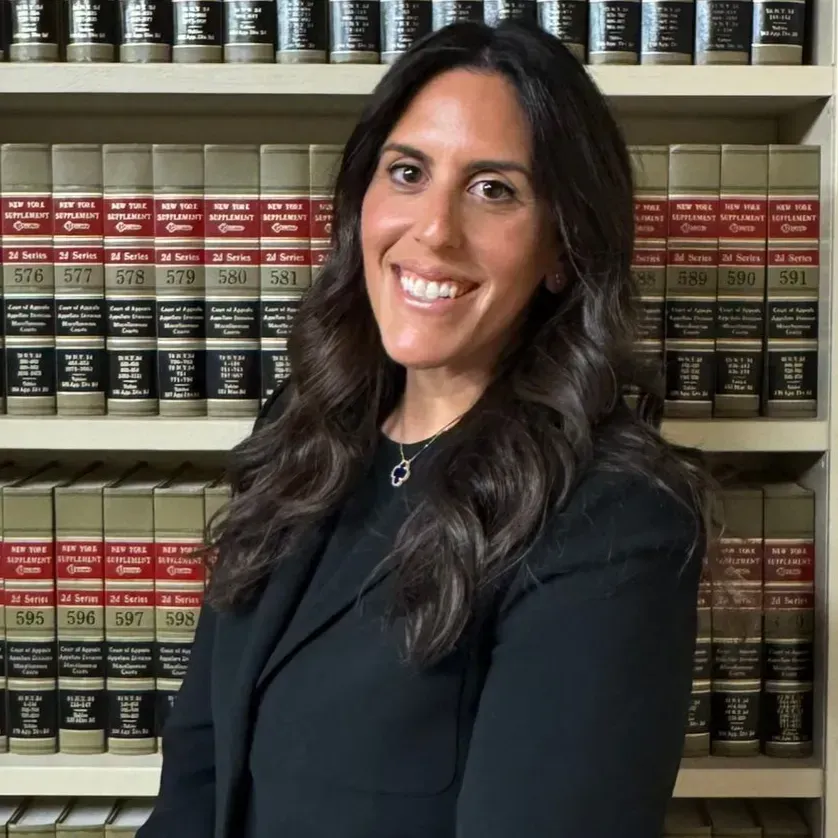 A woman wearing earrings is smiling for the camera